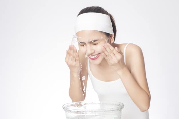 Beautiful woman is washing her face